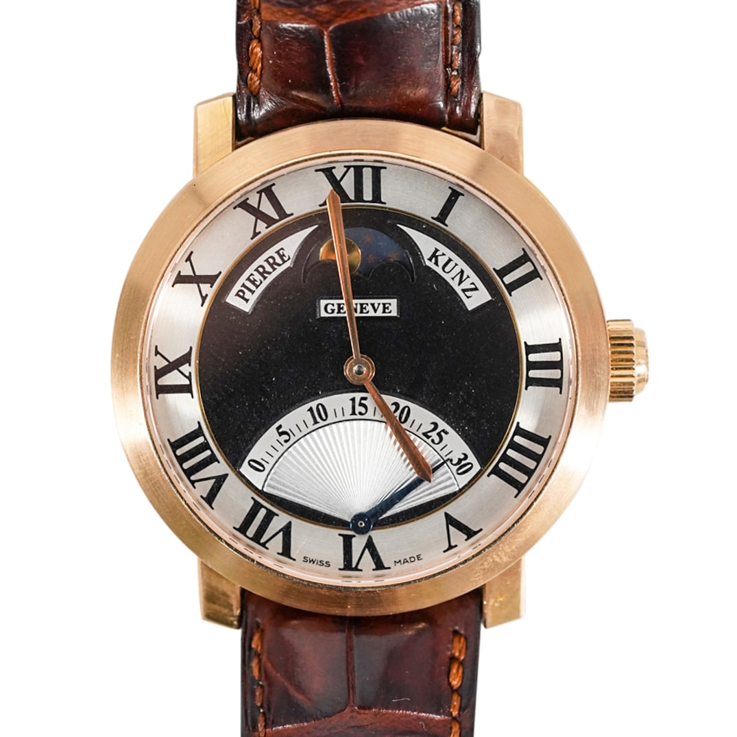 Pierre Kunz 18k Rose Gold Moon Phase Watch: DESCRIPTION: Pierre Kunz 18k Rose Gold Moon Phase Watch REF#PKEQ07SRLOGW, automatic movement, Retrograde, black/silver dial, 18k rose gold case and bezel, attached to a leather band with rose gold buc