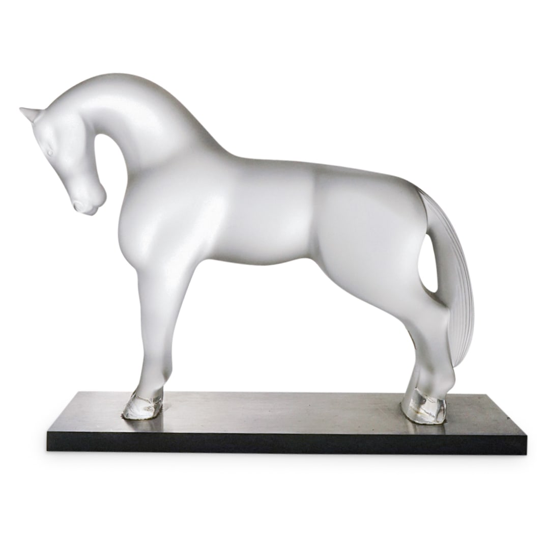 Lalique Crystal Horse Sculpture: DESCRIPTION: Lalique frosted and clear crystal sculpture depicting a horse and mounted to a metal base. CIRCA: Late 20th Century ORIGIN: French DIMENSIONS: H: 5.75" W: 2.25" L: 7" CONDITION: One minor