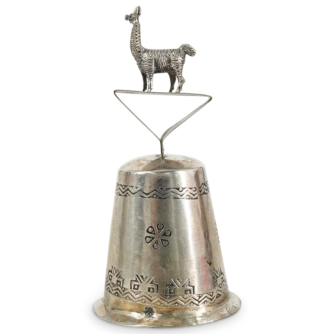 800 Silver Llama Bell: DESCRIPTION: 800 silver bell featuring llama finial. Hallmarked at bottom. Total weight: 20 g. CIRCA: 20th Century ORIGIN: South American, probably Peruvian DIMENSIONS: H: 3" Diameter: 1.5" CONDITION: