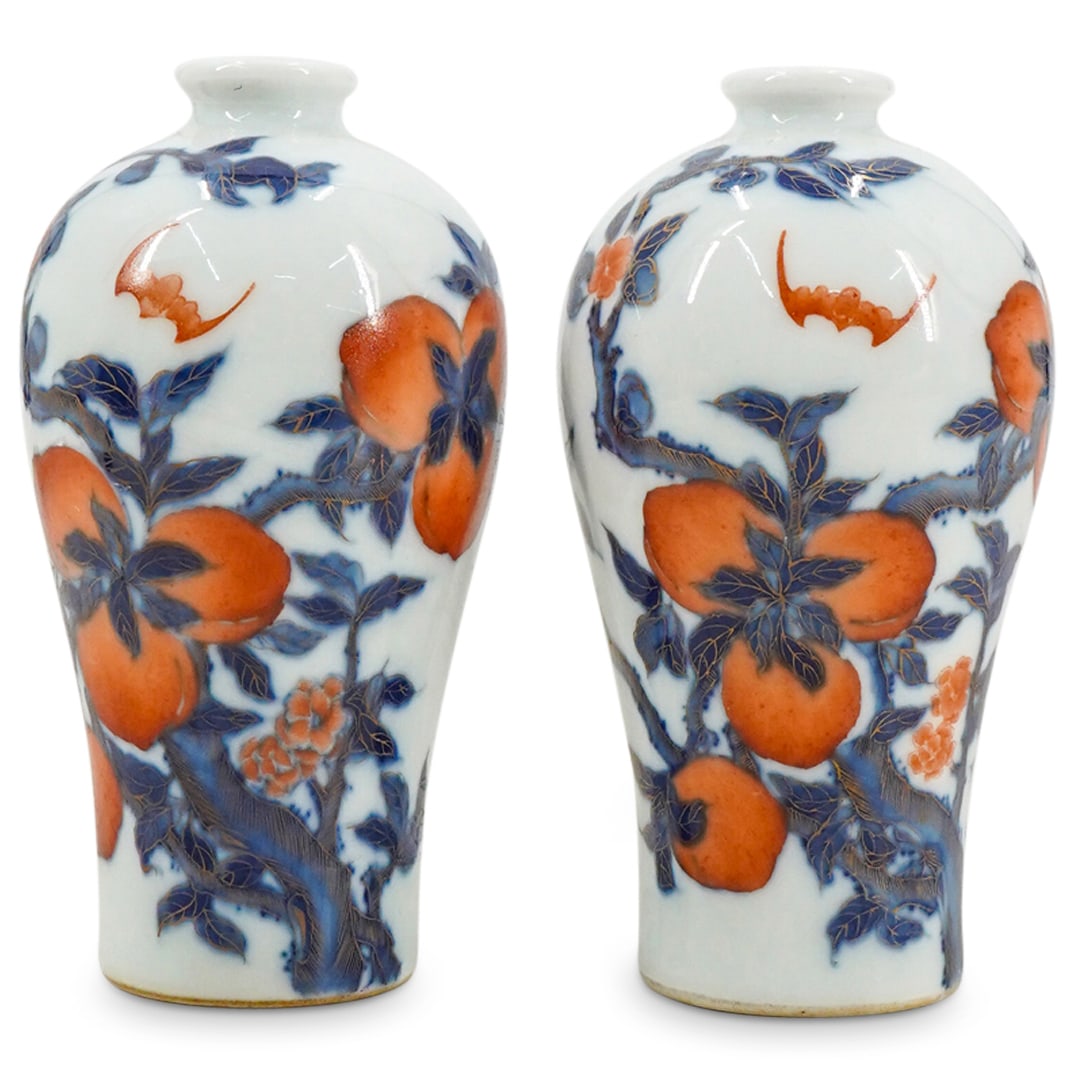 Pair Of Chinese Imari Porcelain Miniature Vases: DESCRIPTION: Two matching miniature porcelain vases, each featuring bat and peach motifs in blue, white, and red finished with gilt accenting. Marked on underside with Han characters. CIRCA: 20th Cent