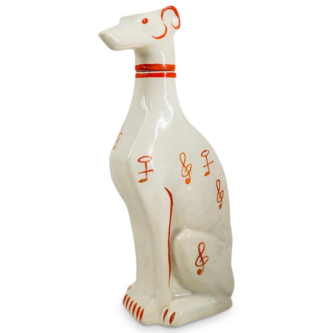 Vintage German Goebel Porcelain Greyhound Decanter: DESCRIPTION: Vintage German Goebel porcelain decanter designed as a greyhound dog, with a cream hued body embellished with painted orange musical note motifs. Marked with Goebel hallmark. CIRCA: 1935-
