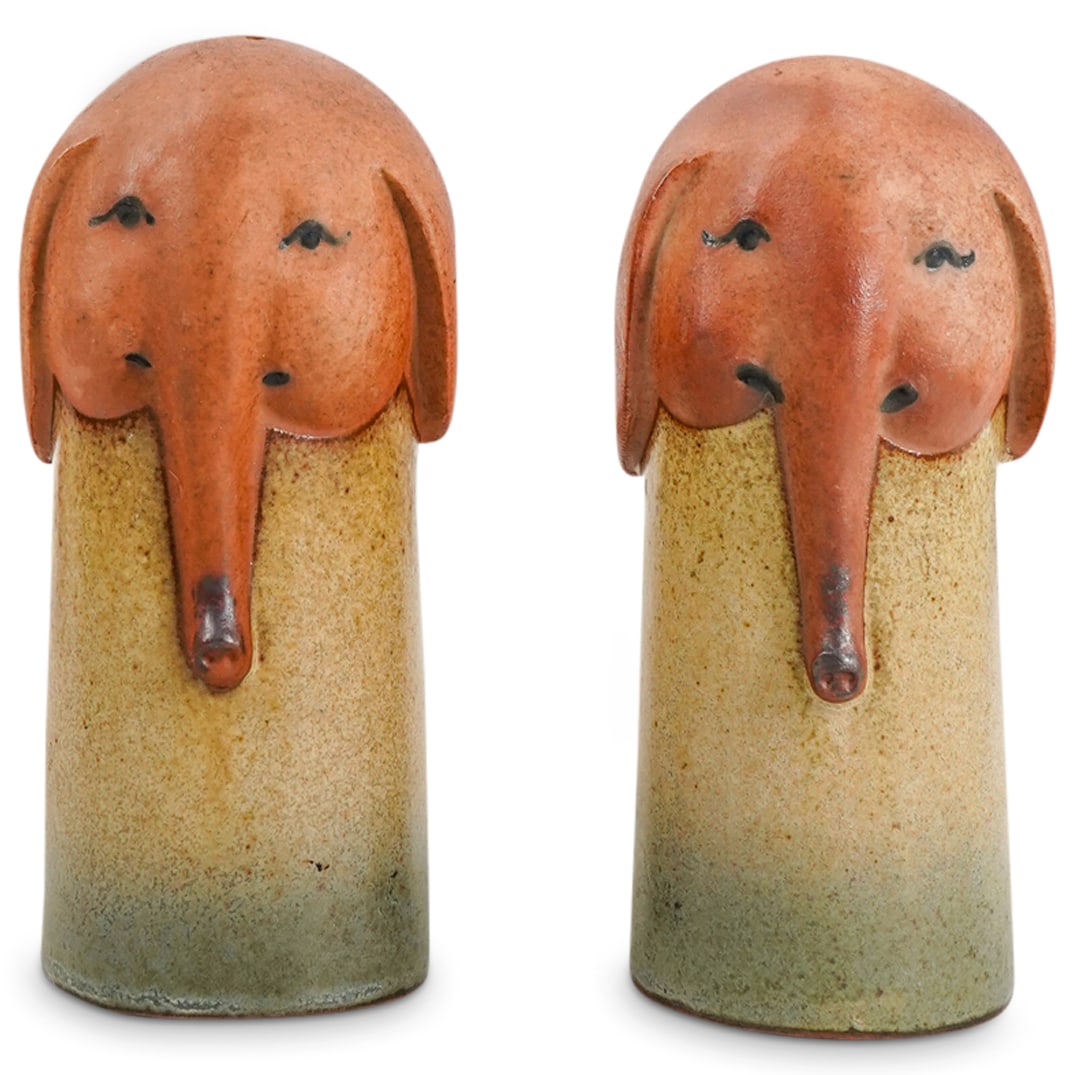 Pair Of Studio Pottery Elephant Condiment Shakers: DESCRIPTION: Two matching condiment shakers, each crowned with an elephant's head. CIRCA: 20th Century ORIGIN: USA DIMENSIONS: H: 4.75" W: 2.25" L: 2.25" CONDITION: In great condition Unless otherwise