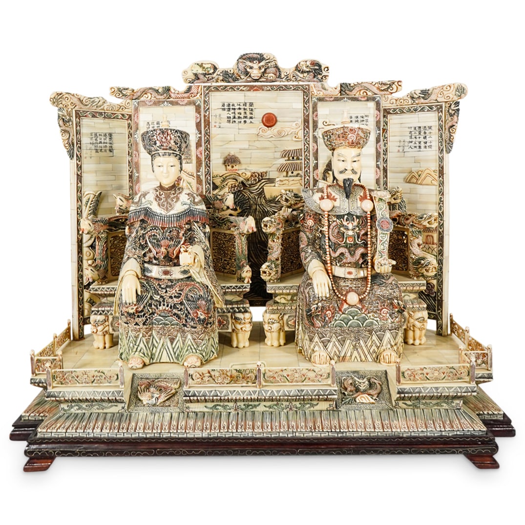 Large Vintage Chinese Carved Bone Imperial Court Scene: DESCRIPTION: Vintage sculpture crafted from carved bone depicting an emperor and empress holding court: the emperor bearing a ruyi and wearing dragon laden robes while seated on a chair rife with drag