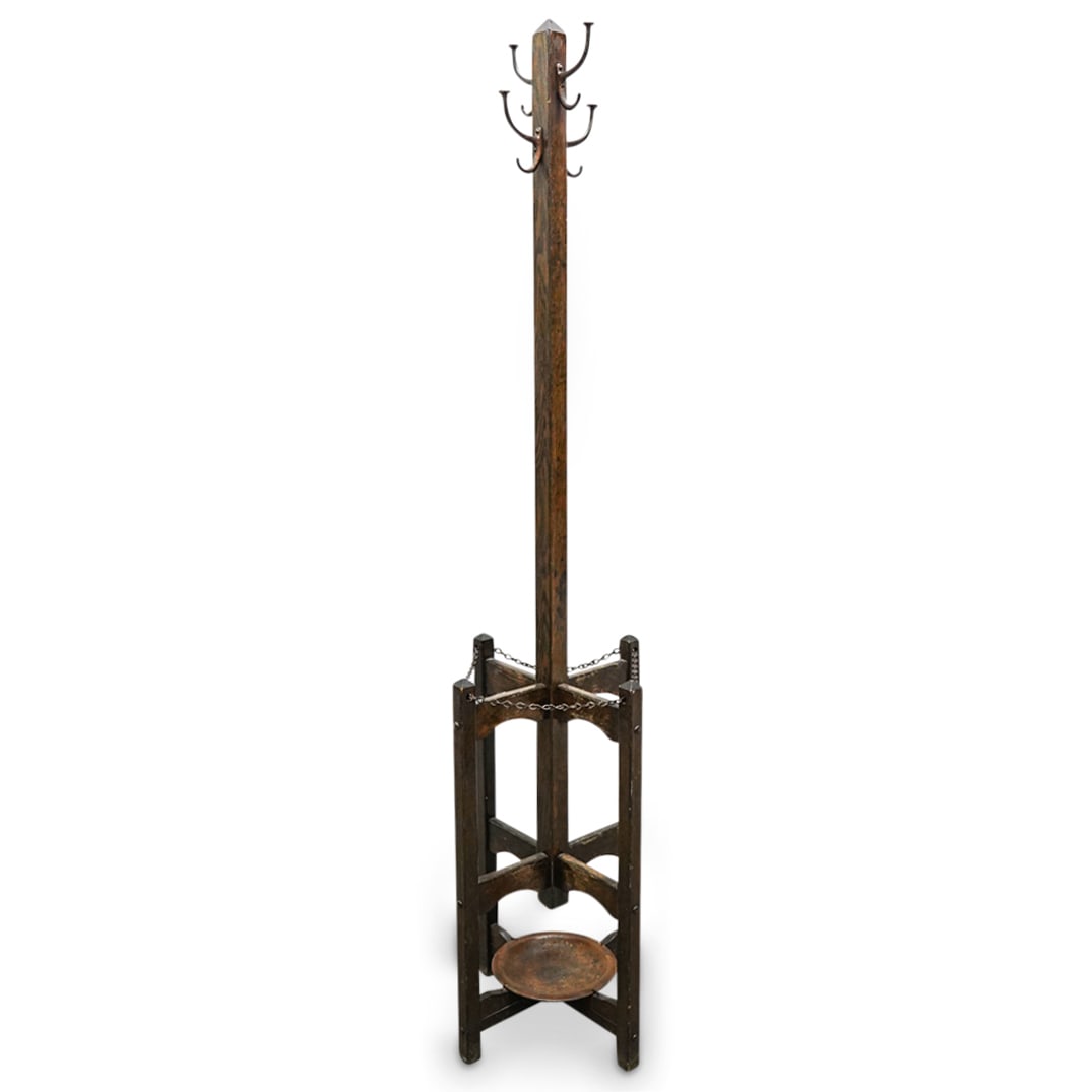 Antique Carved Wood Cane And Coat Rack: DESCRIPTION: Antique four footed coat rack crafted from carved wood and featuring an arrangement of its legs accompanied by a chain and plate fashioned for placing canes. CIRCA: Late 19th to mid-20th