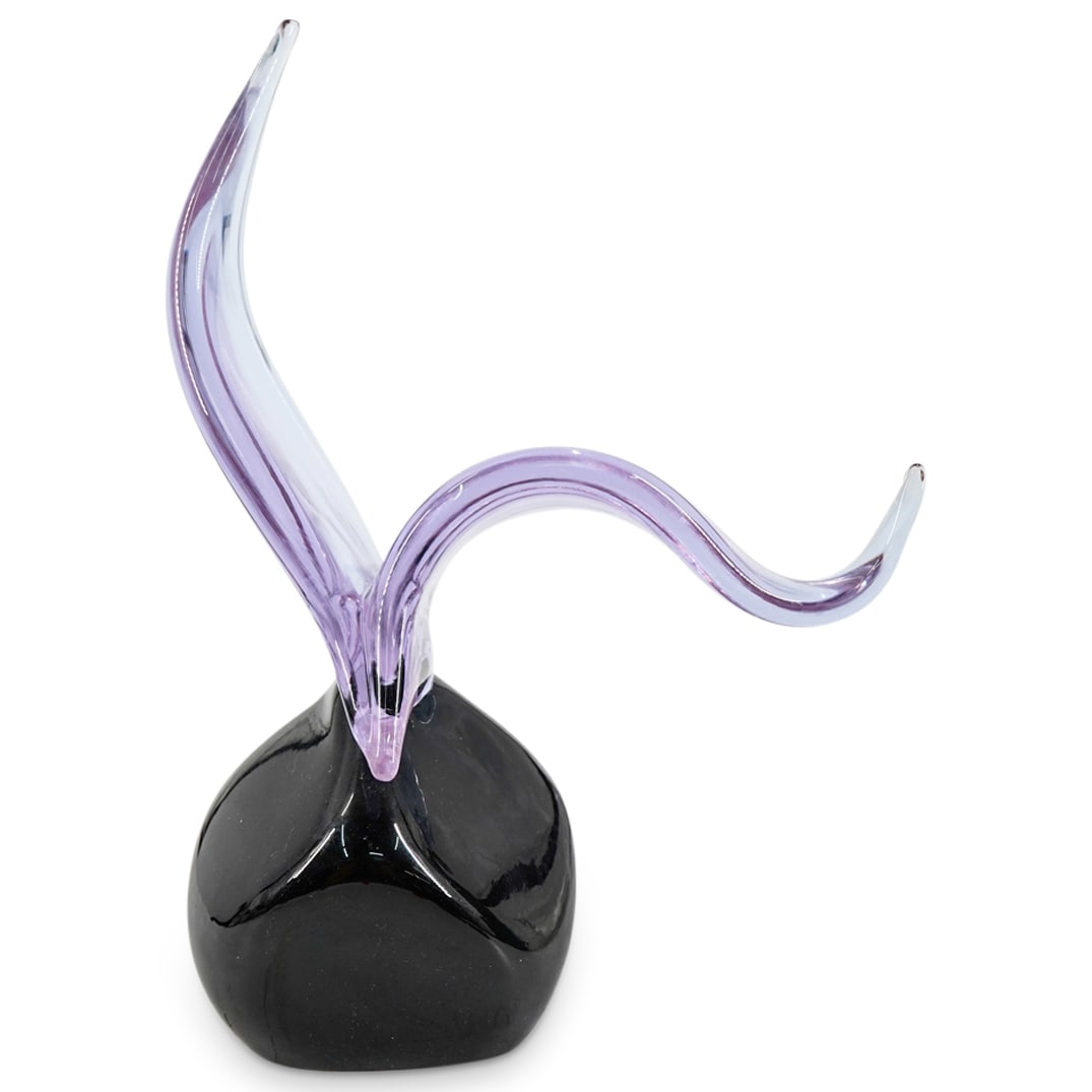 Murano "Seagull On Rock" Sculpture: DESCRIPTION: Murano art glass sculpture depicting a seagull on a rock. The seagull is designed in an amethyst-hued translucent glass. The cube-shaped rock is designed in black glass. Signed on the und