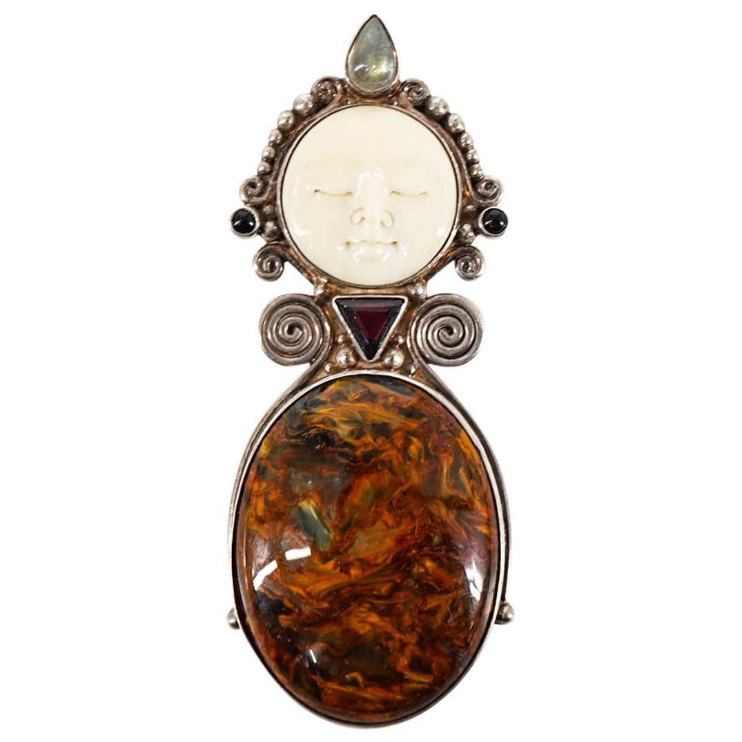 Sajen Sterling Silver Mask Pendant: DESCRIPTION: Sajen sterling silver large mask pendant with oval cabochon. Marked "Sajen 925". CIRCA: 20th Century ORIGIN: DIMENSIONS: H: 3 1/2" W: 1 1/4". Total weight: 34 grs. CONDITION: Good pre-own