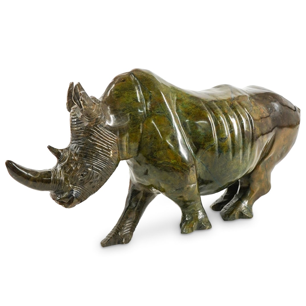 Carved Soapstone Rhino Sculpture: DESCRIPTION: Carved soapstone sculpture depicting a rhinoceros. CIRCA: Late 20th - Early 21st Century ORIGIN: Unknown DIMENSIONS: H: 5.75" W: 4" L: 11.25" CONDITION: Professional repairs to body, horn