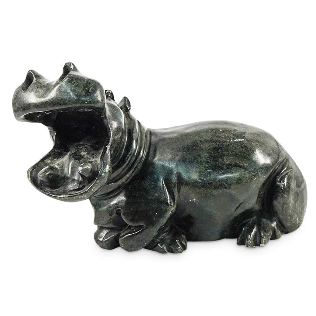 Carved Soapstone Hippo Sculpture: DESCRIPTION: Carved soapstone sculpture depicting a recumbent hippopotamus. Signed "Ckachiki[r?]a" at bottom. CIRCA: Late 20th - Early 21st Century ORIGIN: Possibly African DIMENSIONS: H: 5.25" W: 4.7