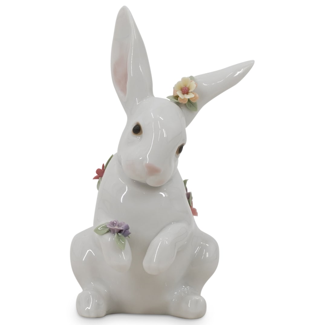 Lladro Porcelain "Sitting Bunny With Flowers" Figurine: DESCRIPTION: Lladro porcelain figurine titled "Sitting Bunny With Flowers" designed by sculptor Fulgencio Garcia. The piece has a glazed finish. Model number: #6100. Stamped on the underside with the 