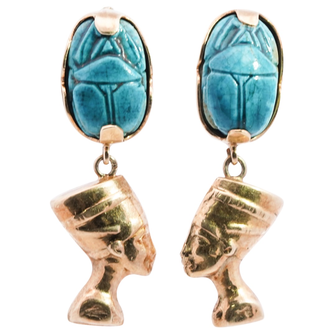 Egyptian 14k Yellow Gold Faience Scarab Earrings: DESCRIPTION: A pair of Egyptian 14k yellow gold earrings with inset faience glazed scarabs and hanging pharaoh busts. Designed with clip on backs. Hallmarked with makers mark. CIRCA: 20th Cent. ORIGIN