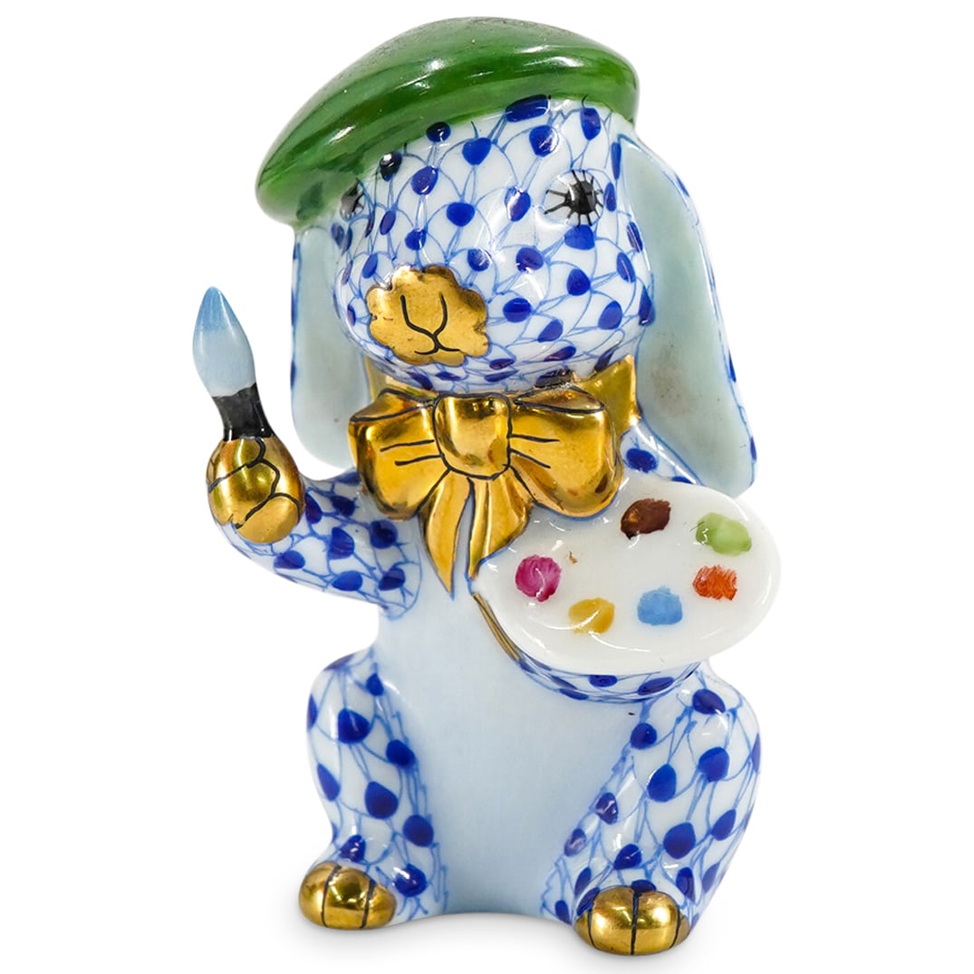 Herend Porcelain "Painter Bunny" Blue Fishnet Figurine: DESCRIPTION: Herend porcelain figurine of a "Painter Bunny" embellished in a blue hued fishnet pattern. Finished with gilded accents. Style: #16173. Marked along the underside with Herend stamps. CIRC