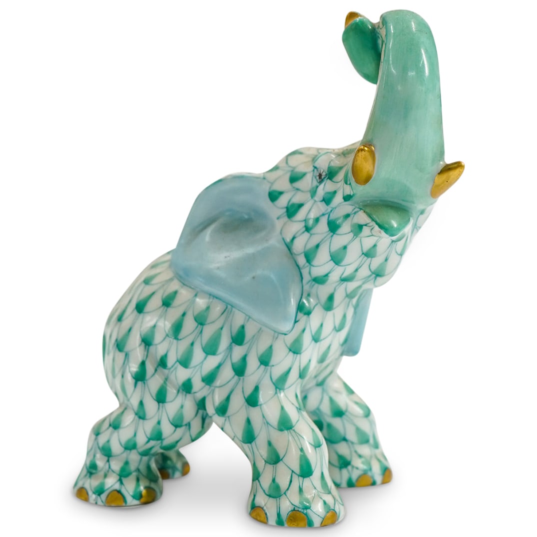 Herend Porcelain "Joyful Elephant" Green Fishnet Figurine: DESCRIPTION: Herend porcelain figurine of a "Joyful Elephant" embellished in a green hued fishnet pattern. Finished with gilded accents. Style: #15266. Marked along the underside with Herend stamps. C