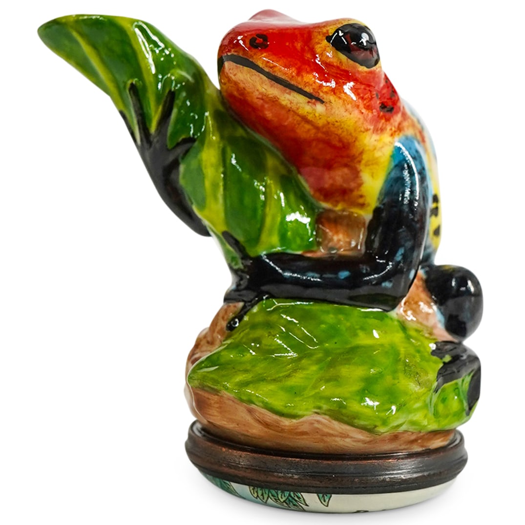 Halcyon Days "Dart Frog" Enamel Bonbonniere Box: DESCRIPTION: A Halcyon Days "Dart Frog" enamel pill bonbonniere box. Features a frog standing on leaves. Opens to reveal a Halcyon Days London logo. Includes original box with white satin lining. CIRC