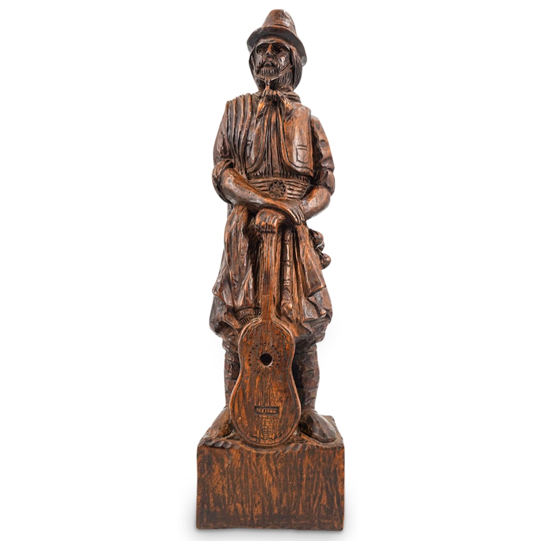 Vintage Hand Carved Wooden Gaucho Figural Sculpture: DESCRIPTION: Vintage hand carved wooden figural sculpture depicting an Argentinian Gaucho male figure holding a guitar. CIRCA: 20th Century ORIGIN: Argentina DIMENSIONS: H: 22" W: 6 1/4" D: 3 3/4" CON