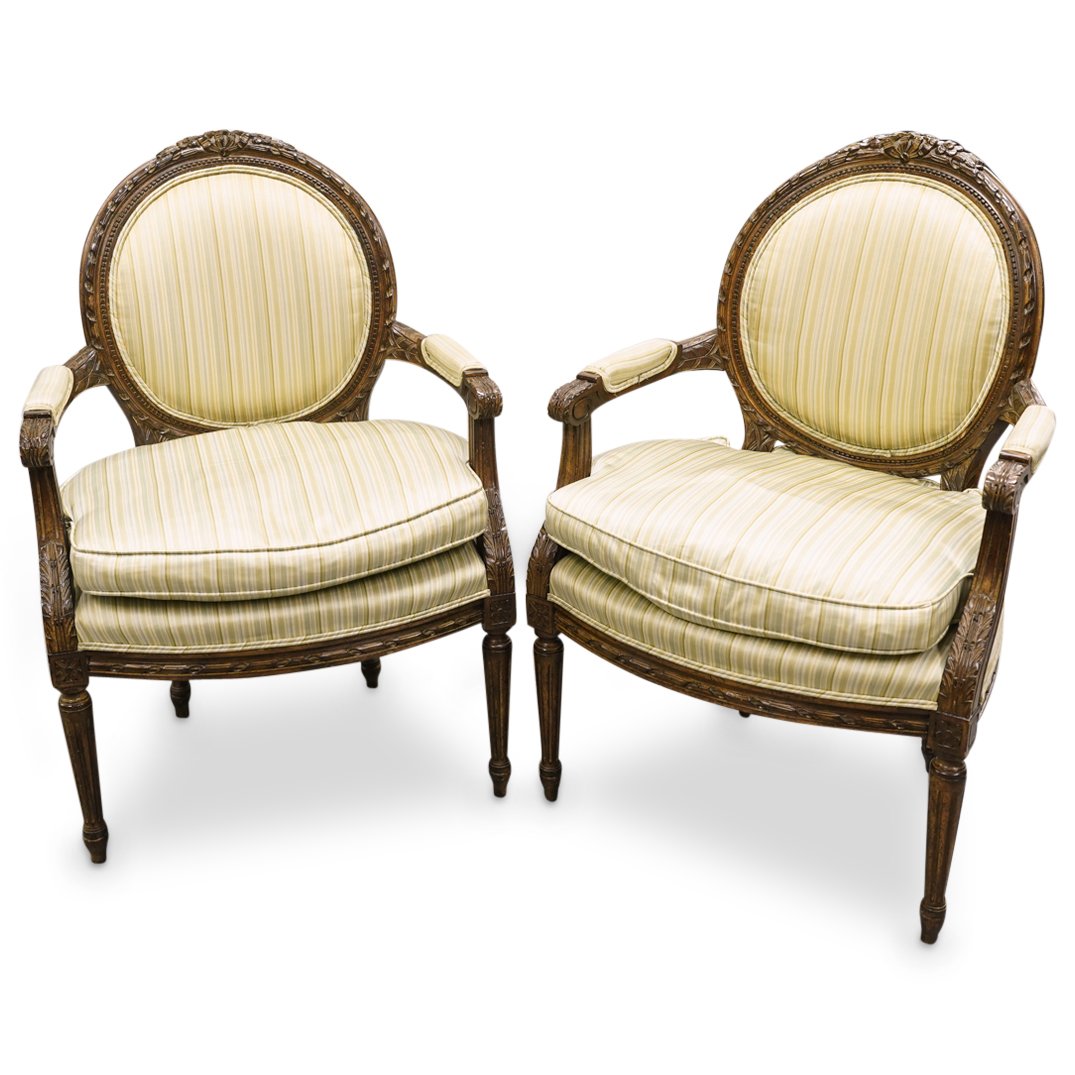 Pair Of Antique French Carved Wood Chairs: DESCRIPTION: Two matching carved wood armchairs, each decorated with floral, foliage, and ribbon designs and upholstered with green and white cushioning. CIRCA: 19h to early 20th Century ORIGIN: Franc
