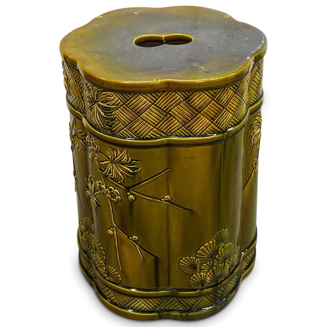 Vintage Chinese Porcelain Stool: DESCRIPTION: Antique porcelain stool crafted in a six-lobed form with raised floral, foliage, and geometric designs and patterns throughout and coated in an ochre glaze. CIRCA: 20th Century ORIGIN: Ch