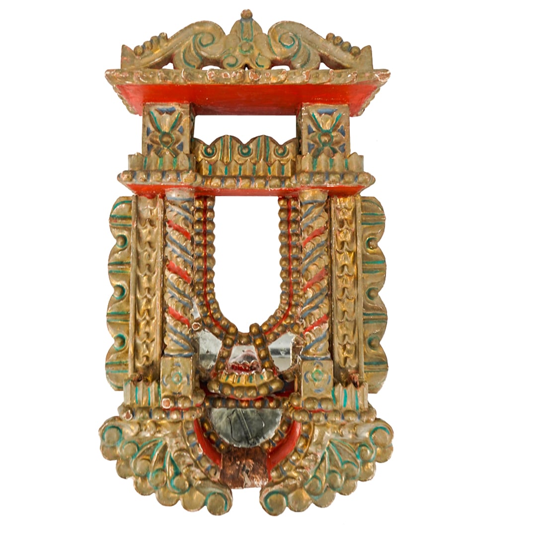 Antique South American Polychrome Carved Wood Mirrored Shrine: DESCRIPTION: Antique shrine carved from wood coated in blue, red, and gilt tones. Effigy platform is fitted with two foliage wrapped and quatrefoil emblazoned columns and stands above a lower platform