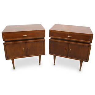 Pair Of Mid Century Modern Wood Nightstands: DESCRIPTION: Two matching mid-century modern nightstands, each carved from wood and featuring a drawer and two doors, the latter of which conceal a cubby. Drawers and doors are adorned with gilt