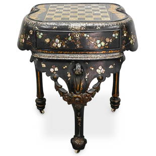 Antique MOP Inlaid Chess Table: DESCRIPTION: Antique wooden chess table featuring mother of pearl inlay, floral motifs, gilt foliage motifs, gilt accents, a single drawer, three legs, and three casters with porcelain wheels. CIRCA: