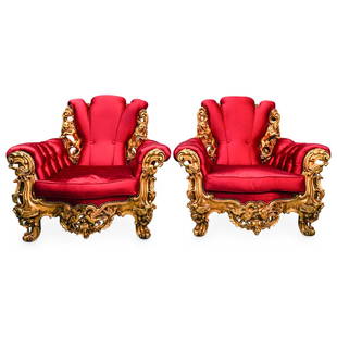 Pair Carved Giltwood Upholstered Arm Chairs: DESCRIPTION: A pair of armchairs crafted with a carved gilt wood foundation displaying ornate motifs with lion and bird decorations. Completed with a burgundy red upholstery. CIRCA: 20th Cent.