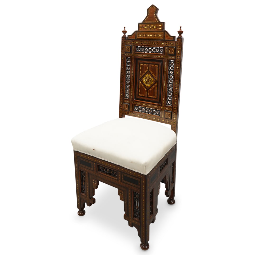 Vintage Syrian Parquetry Chair: DESCRIPTION: Vintage carved wood chair featuring glossy parquetry inserts throughout frame, spindle and lattice patterned inserts, and a white upholstered cushion. CIRCA: 20th Century ORIGIN: Syria DI