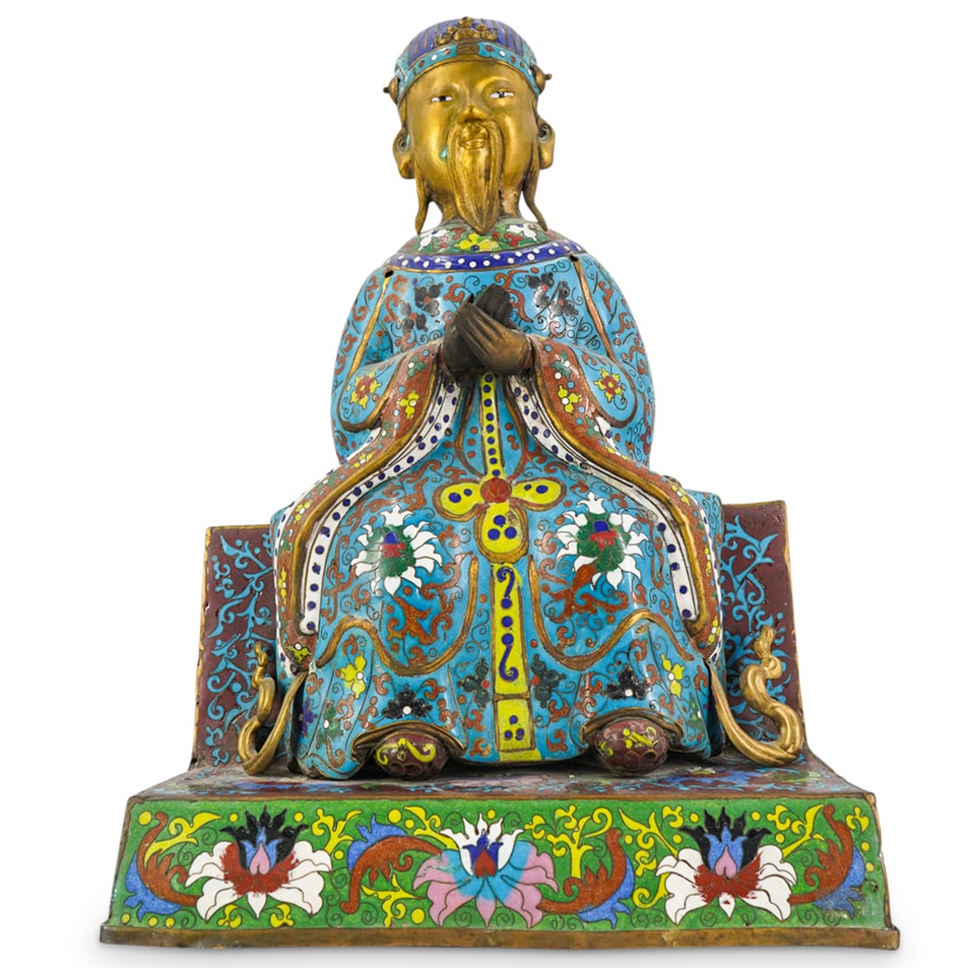 Antique Chinese Cloisonne Seated Scholar: DESCRIPTION: Antique Chinese cloisonne statue depicting a seated scholarly figure with hands together and polychrome draped floral robe. Posed on a tiered base with vibrant enameled lotus flowers and 