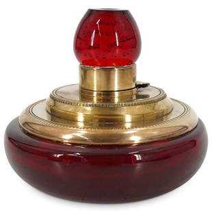 Art Deco Controlled Bubble Paperweight Inkwell: DESCRIPTION: An Art Deco inkwell comprised of an Ruby hued glass body and finial, crafted with controlled bubbles, and mounted with a brass hinge and collar. CIRCA: Early 20th Cent. ORIGIN: USA DIMENS