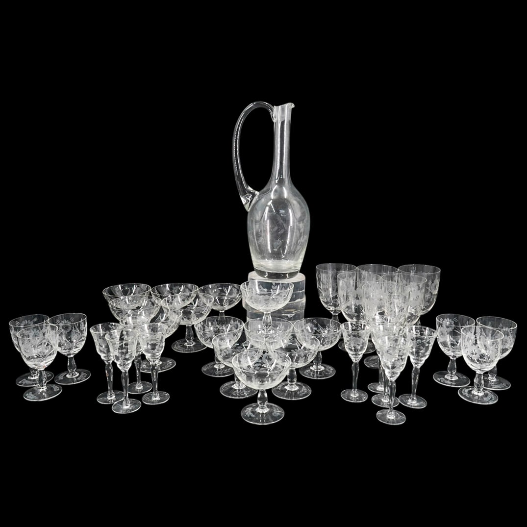 (35 Pc) Etched Glass Crystal Stemware Set: DESCRIPTION: (35 Pc) Etched Glass Crystal Stemware Set, decorated with etched floral motifs. This set includes: (1 Pc) etched glass handled large wine decanter. H: 13" (9 Pc) etched glass cordial glas