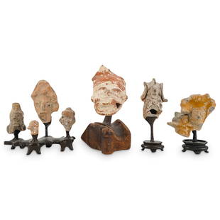 (7 Pc) Pre Columbian Ceramic Figurine Fragments: DESCRIPTION: pre-Columbian ceramic figurines crafted in various shapes and sizes including one of a head sporting a ball inside visible through holes in the sides of its mouth. Includes five carved