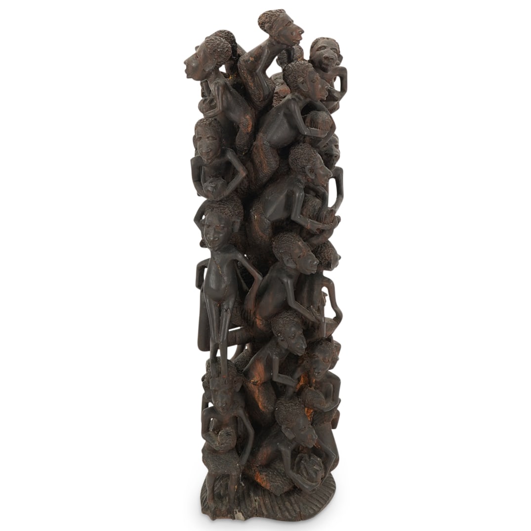 Ujamaa "Tree Of Life" Makonde Family Carved Mpingo Wood Column: DESCRIPTION: Elaborately carved African blackwood ("mpingo") sculpture from a member of the Makonde tribe depicting a family of children stacked atop and around a maternal figure. Signed "BoKo" on und
