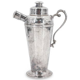 Antique 900 Silver Hammered Cocktail Shaker: DESCRIPTION: Antique 900 silver hand hammered cocktail shaker with ornate scrolling handle, lidded pouring spout and lidded top. Marked at underside with "0900" in shield CIRCA: Early 20th Cent.