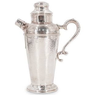 Antique Silver Hand Hammered Cocktail Shaker: DESCRIPTION: Antique silver cocktail shaker with hand hammered foundation, designed with lidded pouring spout and ornate greek key trims, completed with a scrolling spout. CIRCA: Early 20th Cent. ORIG