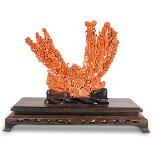 Large Fine Chinese Carved Red Coral Figural Group: DESCRIPTION: A large Chinese carving featuring the depiction of double Guanyin's surrounded by cherry blossom flowers and two playful figures below. Displayed on wood carved stand. CIRCA: Early 20th C