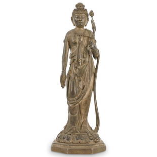 Important 19th C. Silver Model Figure of Kannon by Takamura Koun (1852-1934): DESCRIPTION: 19th Century silver figure of Kannon by Takamura Koun (1852-1934). Features Kannon standing on an octagonal and stepped base with inverted lotus petal, his hair piled into a tall topknot,