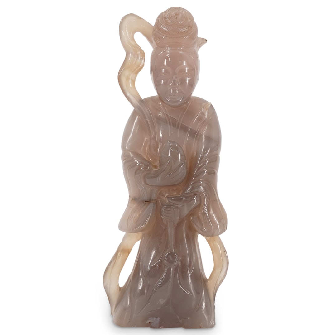 Chinese Carved Agate Figural Sculpture: DESCRIPTION: Chinese carved agate figural sculpture of a woman, possibly a Taoist Immortal. CIRCA: 20th century or later ORIGIN: Chinese DIMENSIONS: H: 7" W: 1.75" L: 3" CONDITION: Loss at upper right