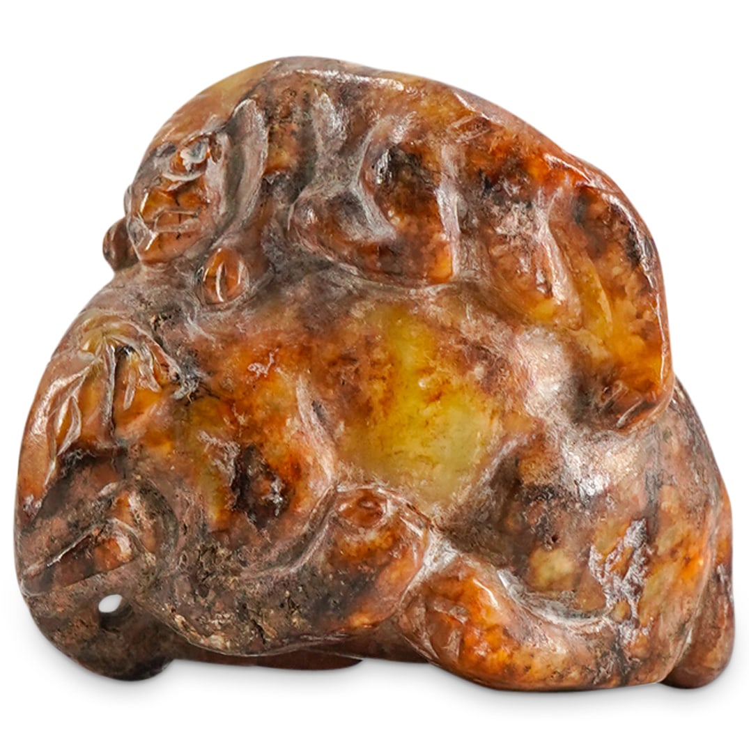Chinese Jade Carving: DESCRIPTION: Chinese carved jade carving depicting a cat resting atop an elephant, carved with naturalistic details and russet veins. CIRCA: 20th Century ORIGIN: China DIMENSIONS: H: 1 3/4" W: 2" COND
