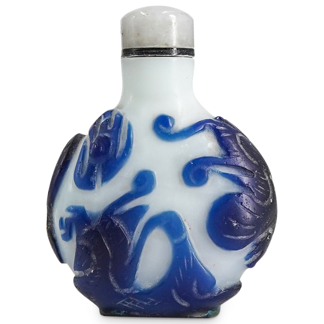 Antique Chinese Peking Glass Blue And White Snuff Bottle: DESCRIPTION: Antique snuff bottle carved from Peking glass featuring blue dragon reliefs against a white body. Provenance: Estate Of David Schofield, Chinese Villages. CIRCA: Late 19th to early 20th C