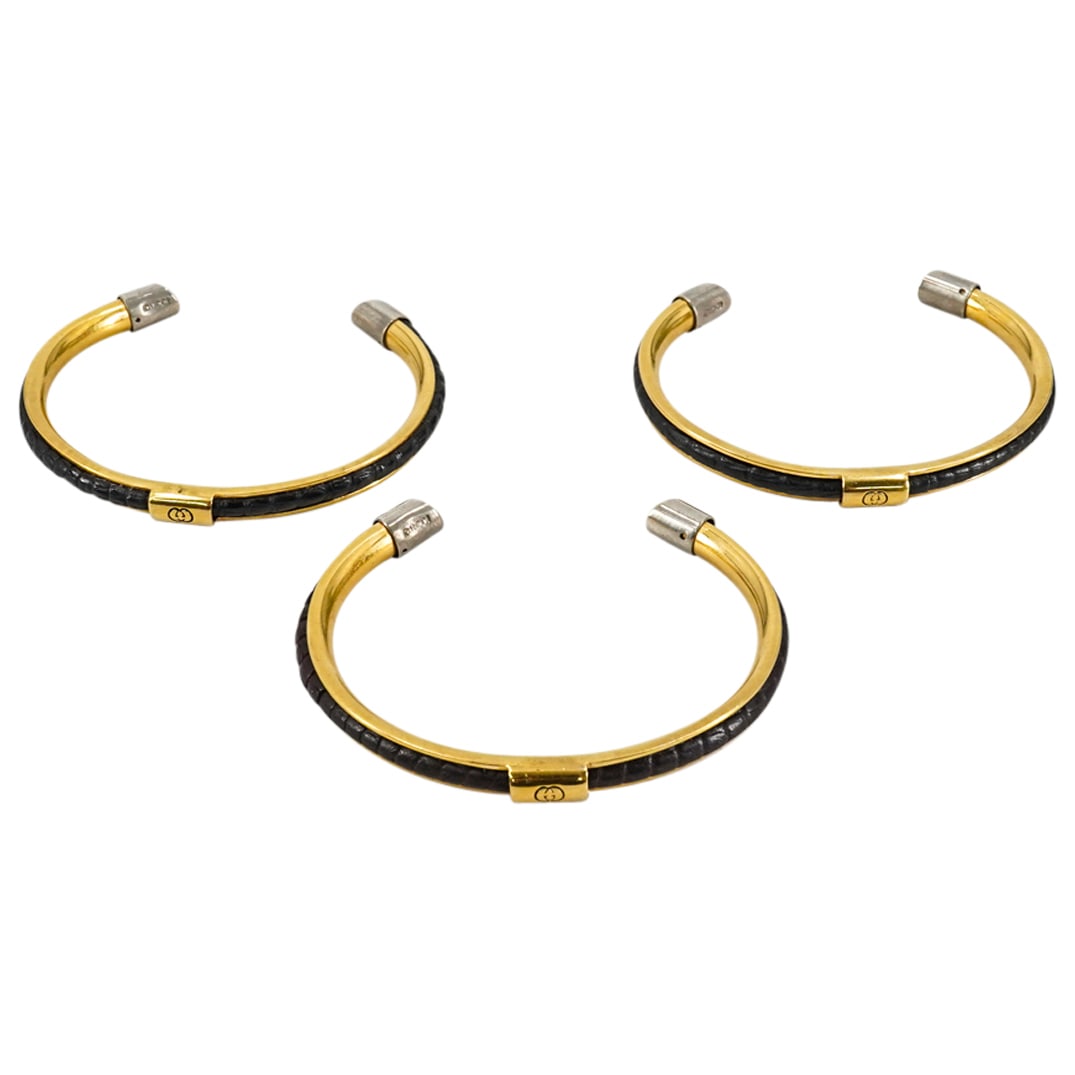 (3Pc) Gucci Gold Toned Snakeskin Cuffs: DESCRIPTION: (3Pc) Gucci designer gold toned cuffs with snakeskin accents. Stamped: "Gucci, Made in Italy. CIRCA: 1970s ORIGIN: Italy DIMENSIONS: Inner Dia: 62mm (Outer) Dia: 70mm CONDITION: Mild scuf