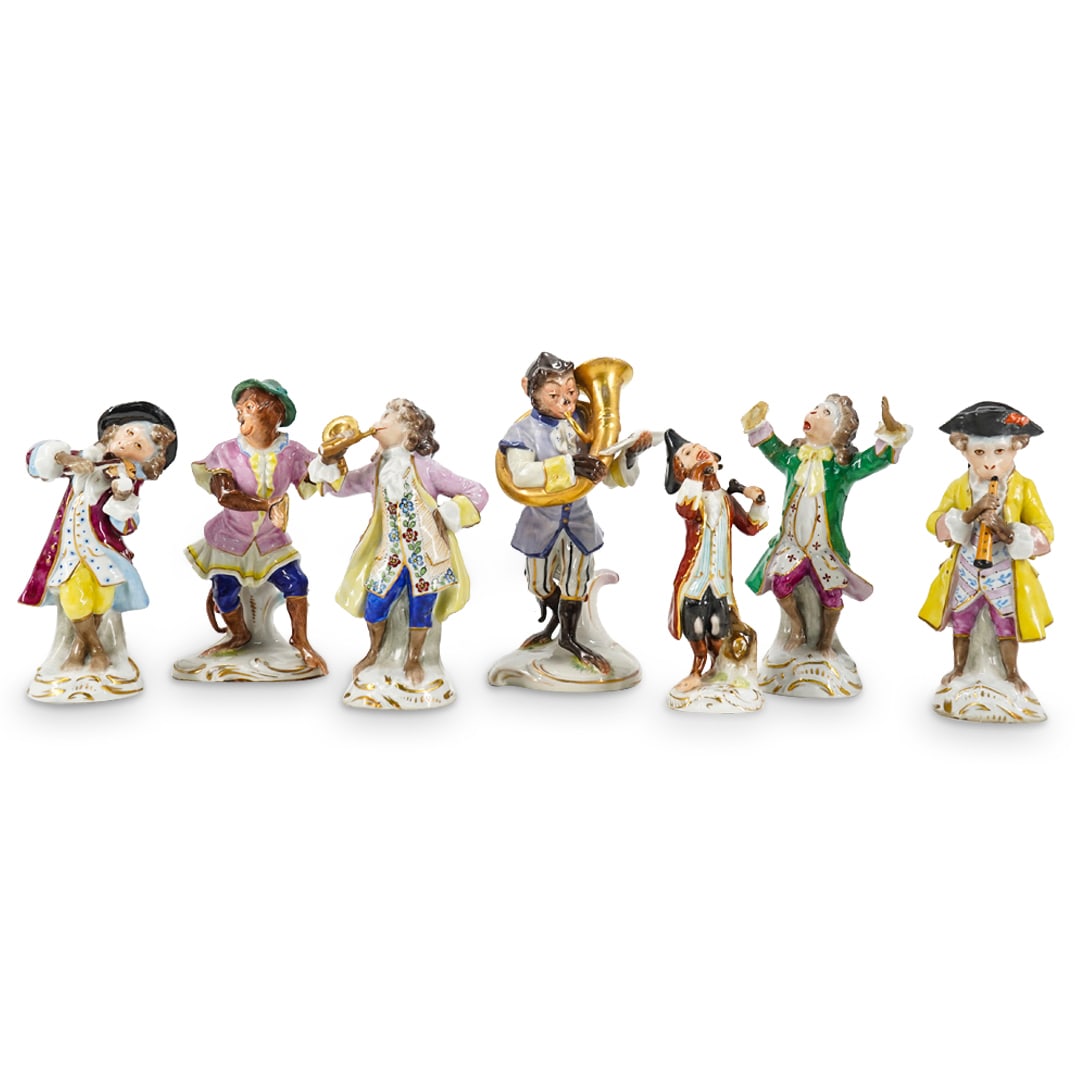 (7 Pc) German Porcelain Monkey Musicians: DESCRIPTION: Seven porcelain monkey musicians - six with instruments, one conducting - each dressed in victorian garb and standing on a gilt accented base. Tuba and cymbals monkeys are Volkstedt; cond