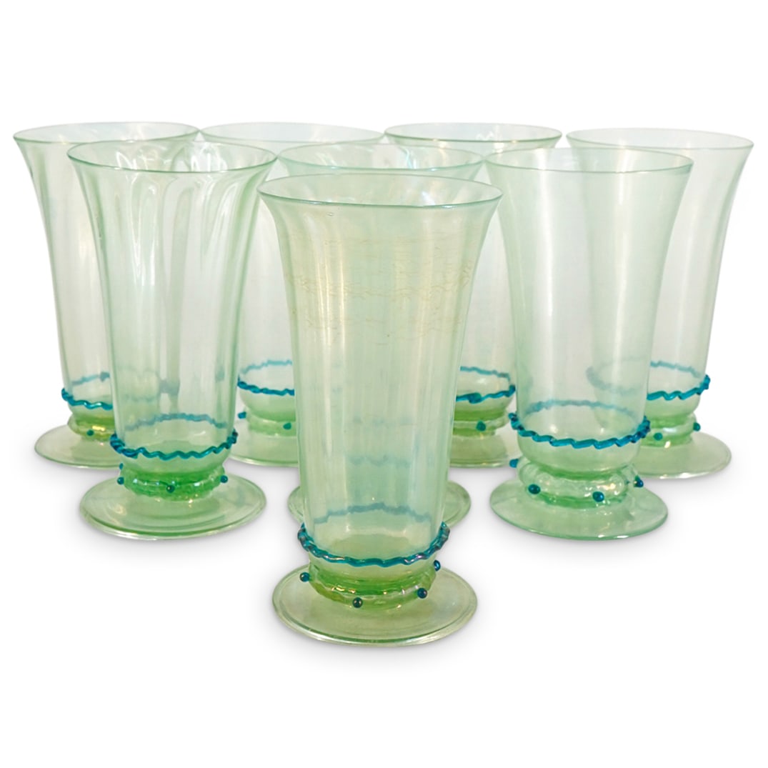 (8 Pc) Murano Blown Water Glasses: DESCRIPTION: Eight Murano glass wine glasses, possibly by Salviati, each in green iridized glass with applied blue collar and beads. CIRCA: 20th Century ORIGIN: Italy DIMENSIONS: H: 6.5" D: 3.75" COND