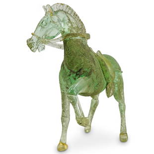 Pino Signoretto Murano Scavo Glass Figure Of A Horse: DESCRIPTION: In transparent green colored glass, with a corroded finish and gold foil fleck, modeled in Chinese style, with one hoof raised. Signed on underside. CIRCA: 20th century or later ORIGIN: I