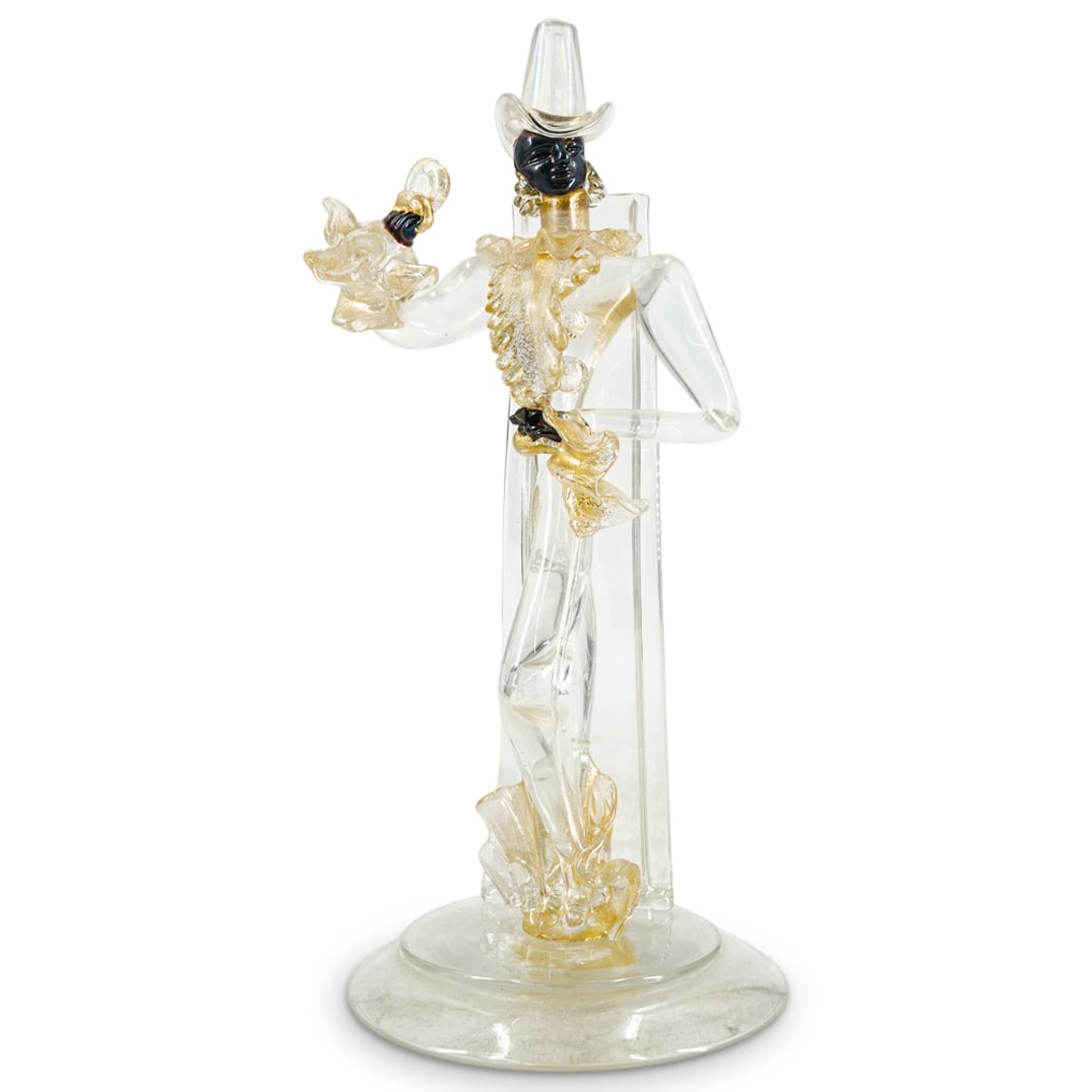 Probably Flavio Poli For Seguso Murano Glass Figure Of A Fashionable Man: DESCRIPTION: In colorless glass and iridized black colored glass, with applied gold fleck decoration. Unsigned. CIRCA: Mid 20th century ORIGIN: Italian DIMENSIONS: H: 10.75" Diameter: 4.75" CONDITION:
