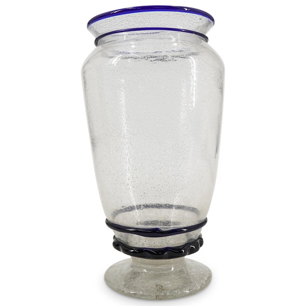 Murano Blown Glass Bubble Vase: DESCRIPTION: Murano glass vase featuring prominent internal bubbles and cobalt rigaree on lip, neck, and above foot. CIRCA: 20th Century ORIGIN: Italy DIMENSIONS: H: 8.25" L: 4.75" CONDITION: Scratch 