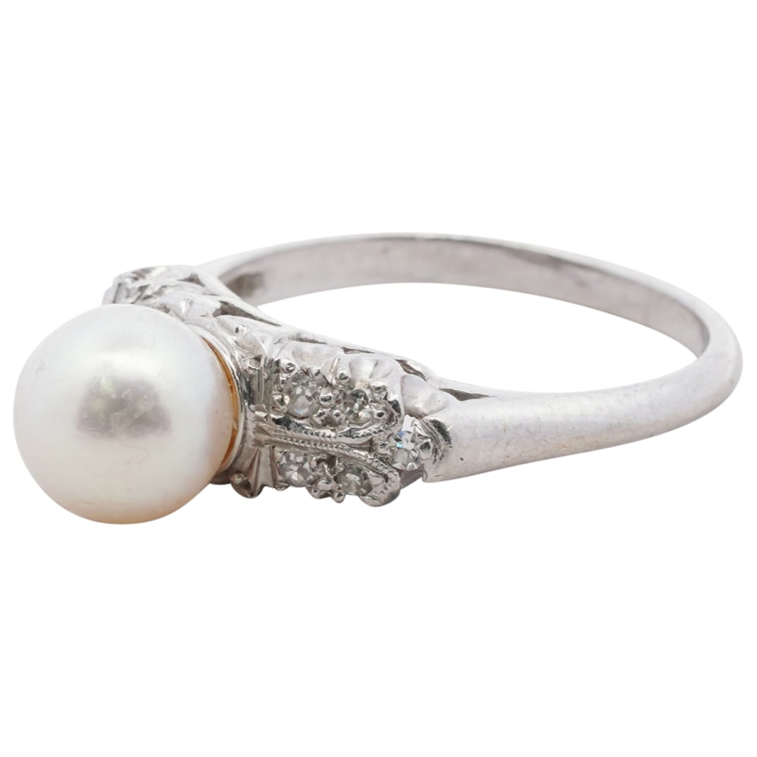 Vintage Platinum, Diamond and Pearl Ring: DESCRIPTION: A vintage Platinum ring decorated along the shoulders with diamond inserts, further centered by a single beaded pearl. Stamped along the inner band "90% Plat". Total Weight:4.8 Grams (3.1