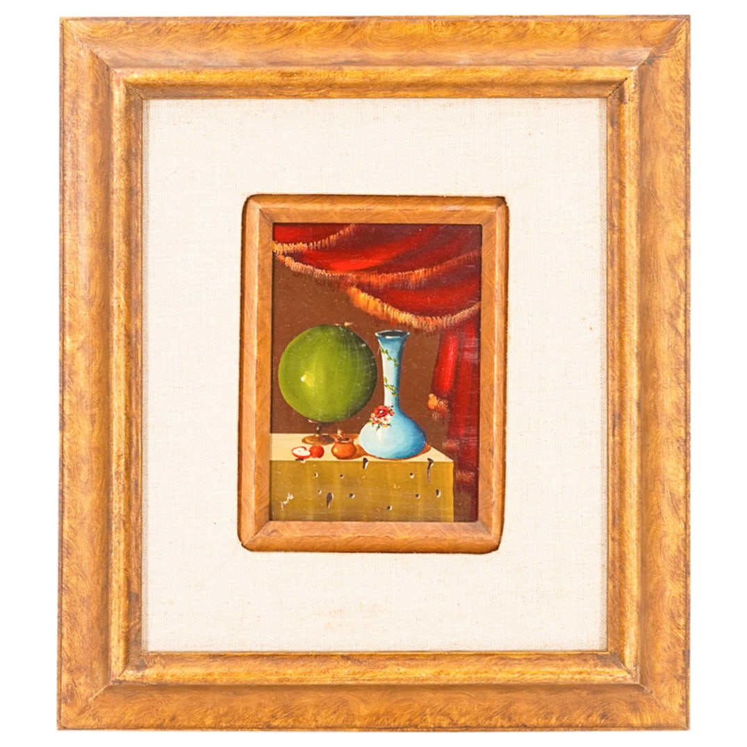 Signed Inde Still Life Enamel On Copper: DESCRIPTION: Enamel on copper painting depicting a still life of a green globe, a blue vase, a mustard jar, and apples on a platform beneath a curtain. Signed "Inde" at lower left. Mounted in a fabric