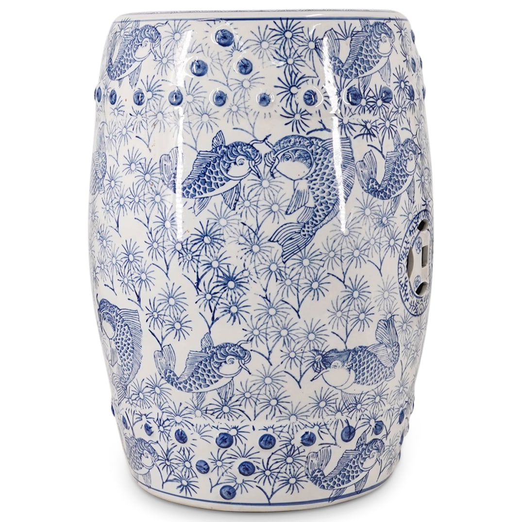 Chinese Blue & White Porcelain Garden Seat: DESCRIPTION: Chinese blue & white porcelain garden seat, of drum form, decorated with floral and koi fish motifs. CIRCA: 20th century ORIGIN: Chinese DIMENSIONS: H: 17.75" Diameter: 13" CONDITION: Gre