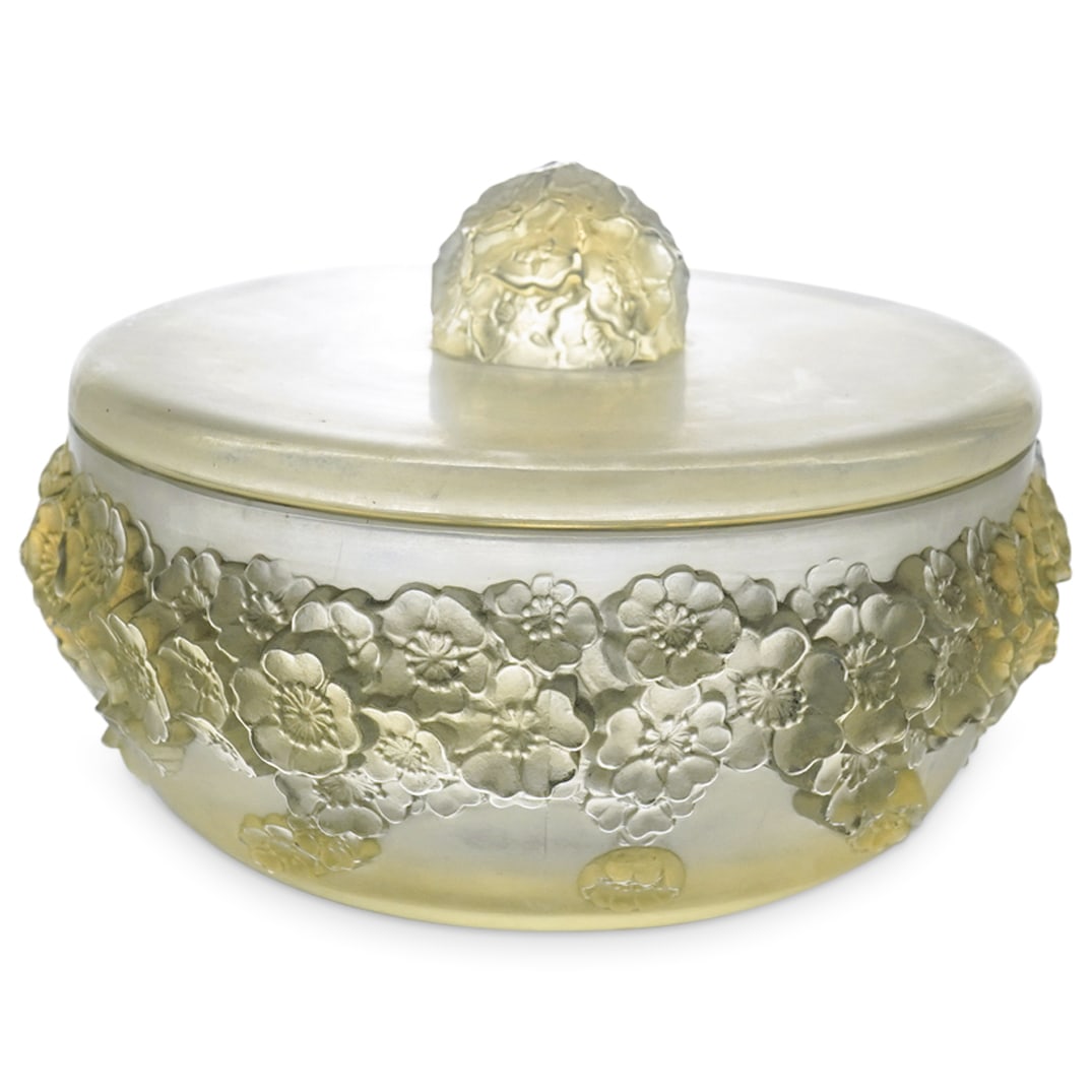 Rene Lalique (French, 1860-1954). "Primeveres" Powder Box: DESCRIPTION: Rene Lalique (French, 1860-1954). "Primeveres" powder box in opalescent glass with a top finial of a cluster of flowers with the box having a circling band of flowers. Marked: R. Lalique,
