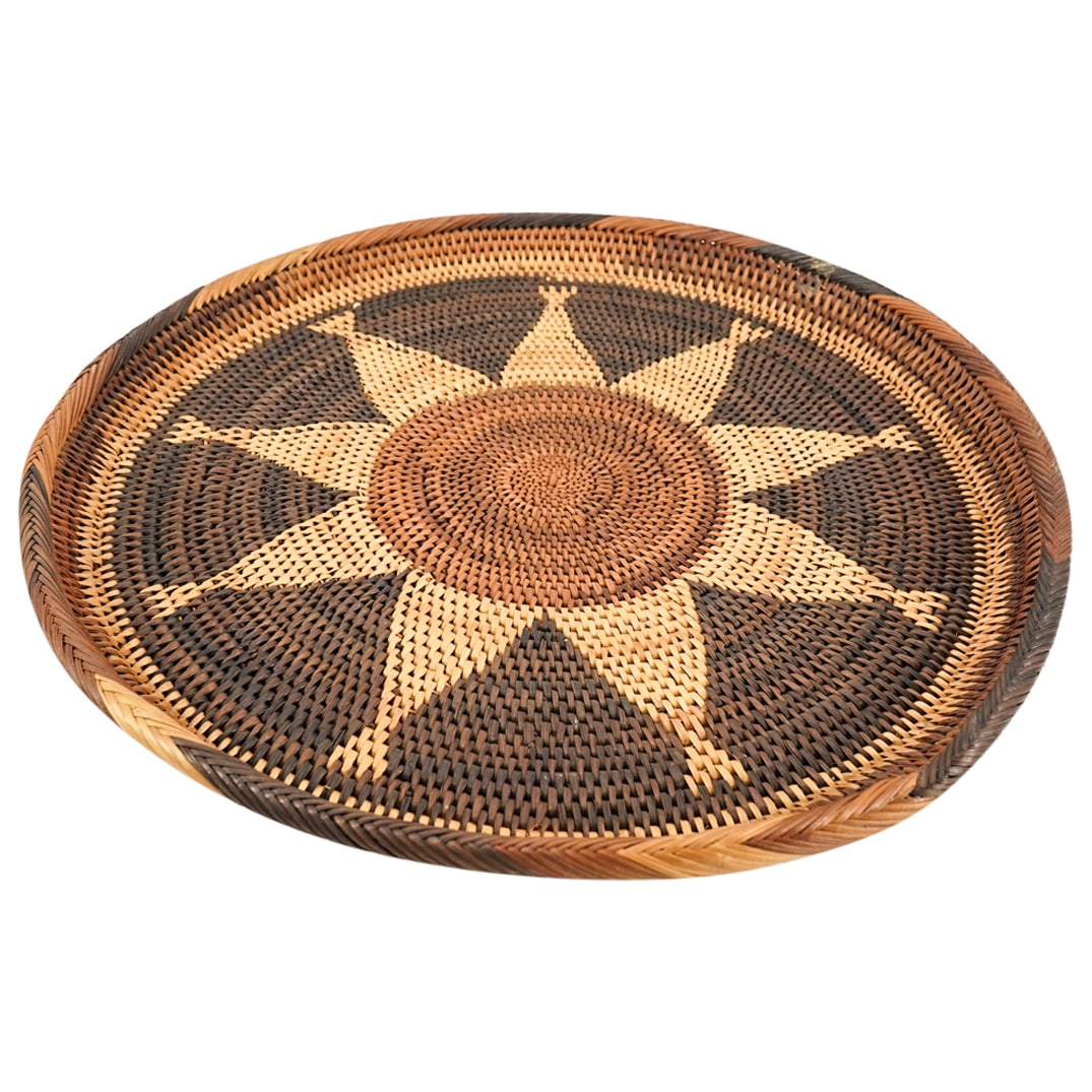 Native American Woven Platter: DESCRIPTION: Vintage woven platter featuring a solar motif in various shades of yellow and brown. CIRCA: 20th Century ORIGIN: United States DIMENSIONS: H: 1.5" D: 18.25" CONDITION: Minor wear consiste