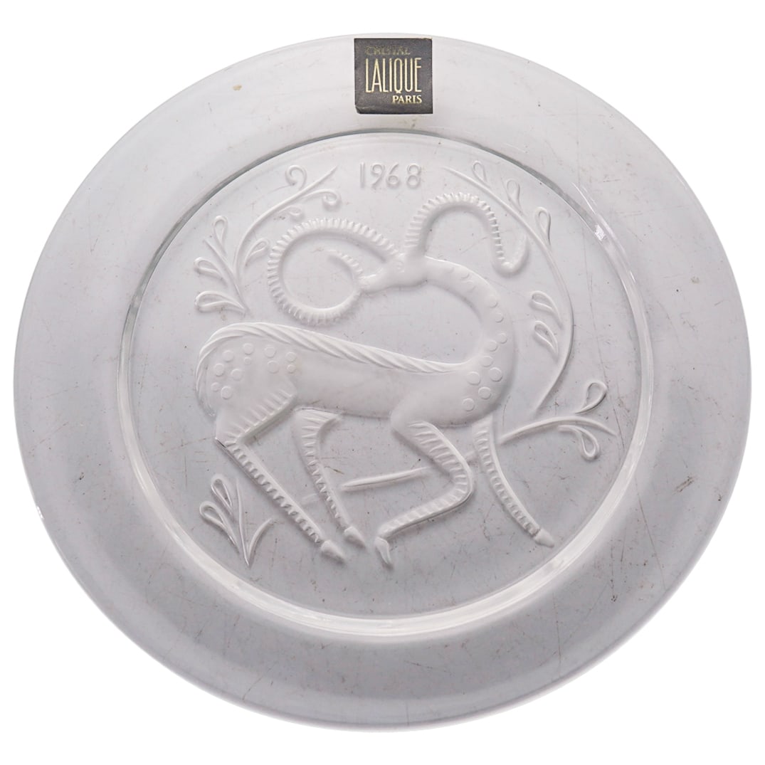 Lalique France Collector Plate In Clear And Frosty Glass: DESCRIPTION: Lalique France collector plate in clear and frosty glass with original box. Year 1968. Signed "Lalique France" in script. CIRCA: 1968 ORIGIN: France DIMENSIONS: D: 8.125" CONDITION: Excel