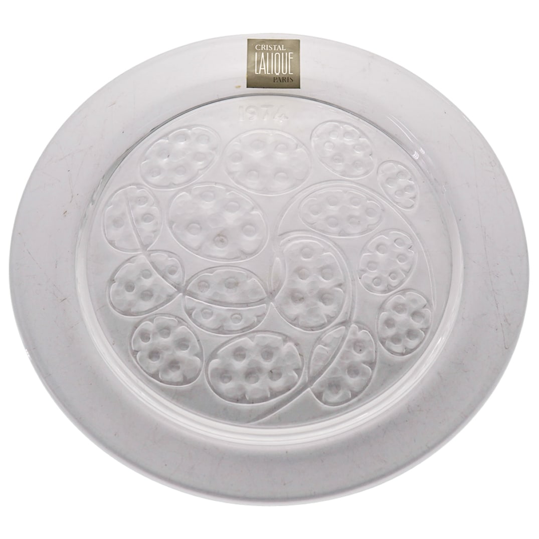 Lalique France Collector Plate In Clear And Frosty Glass: DESCRIPTION: Lalique France collector plate in clear and frosty glass with original box. Year 1974. Signed "Lalique France" in script. CIRCA: 1974 ORIGIN: France DIMENSIONS: D: 8.125" CONDITION: Excel